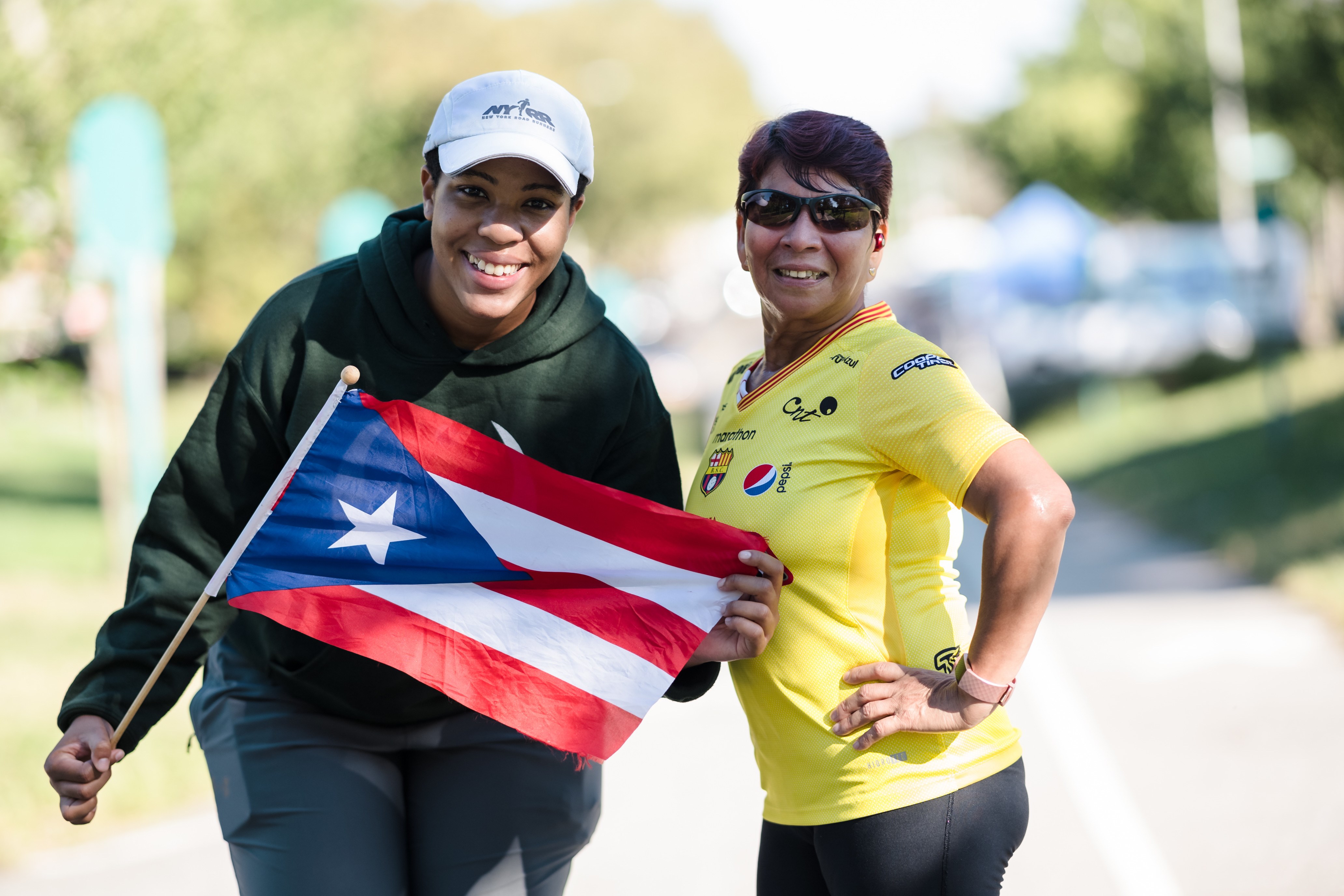 Two runners pose for a picture at a Hispanic Heritage Month Open Run